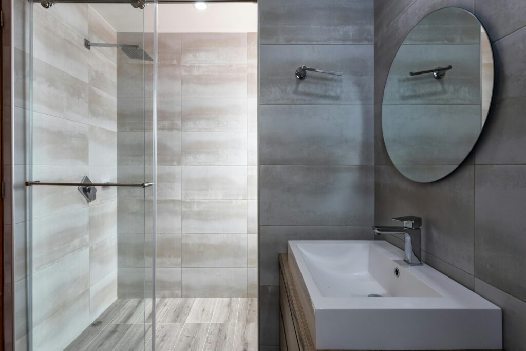 salle de bain 1 vasque, un miroir et un receveur de douche